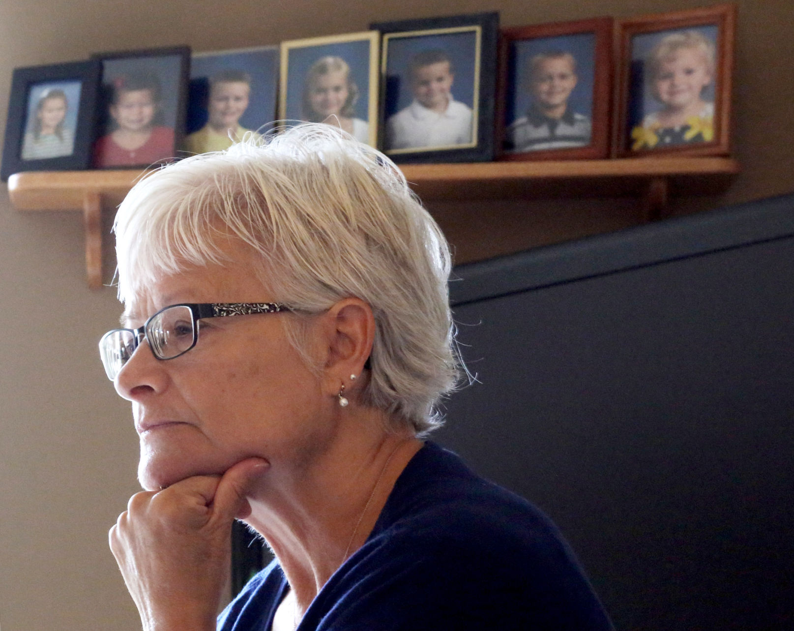 Terry Flugaur with photos of grandchilren in the background